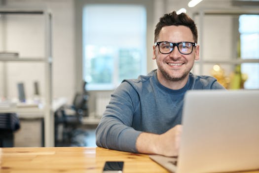 Happy man working on computer
