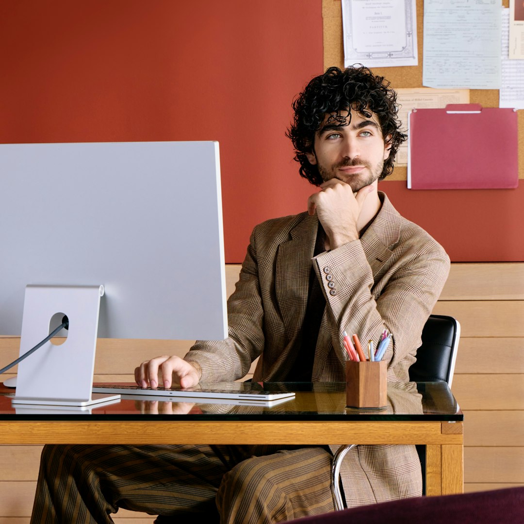 Man at computer looking thoughtful